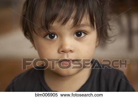 Stock Photography - Serious mixed race boy. Fotosearch