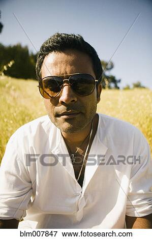 Serious mixed race man in field View Large Photo Image Stock Photo - Serious mixed race man in field. Fotosearch