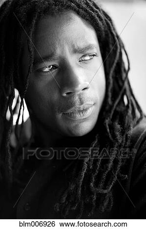 Stock Photograph - Serious mixed race man with dreadlocks. Fotosearch