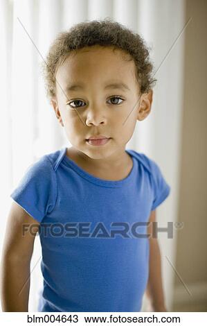 Stock Image - Serious mixed race young boy. Fotosearch