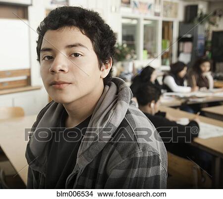 Picture - Serious student in classroom. Fotosearch