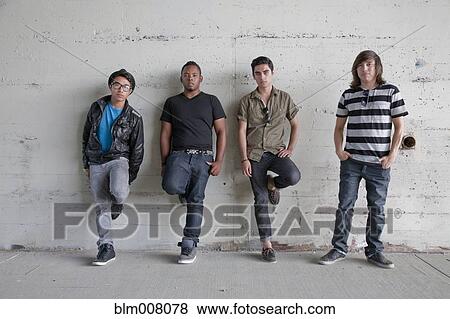 Stock Photo - Serious teenage boys leaning against wall. Fotosearch