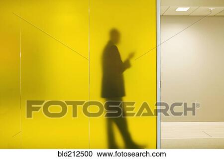 Stock Image - Silhouette of Caucasian businessman in office. Fotosearch