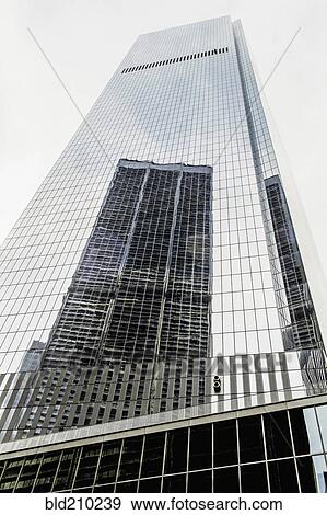 Stock Photo - Skyscraper reflected in building windows, New York, New York, United States. Fotosearch