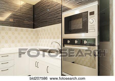 Stock Photograph - Small modern kitchen decorated by black glass. Fotosearch