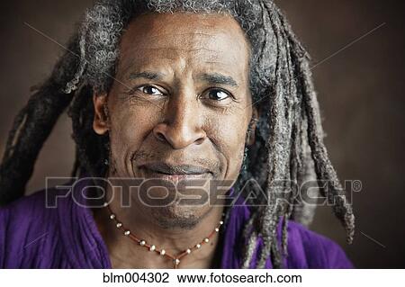 Stock Image - Smiling African man with dreadlocks. Fotosearch