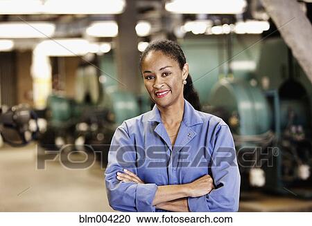 Smiling African technician with arms crossed in industrial plant View Large Photo Image Stock Image - Smiling African technician with arms crossed in industrial plant. Fotosearch