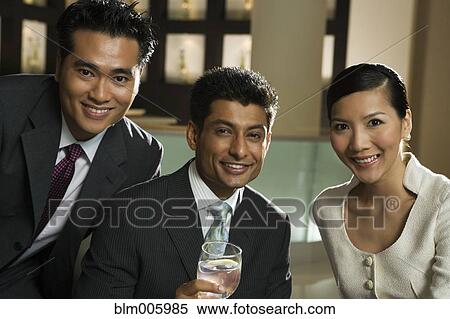 Stock Photography - Smiling business people in restaurant. Fotosearch