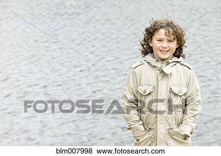 Smiling Caucasian boy with hands in pockets View Large Photo Image Stock Photo - Smiling Caucasian boy with hands in pockets. Fotosearch