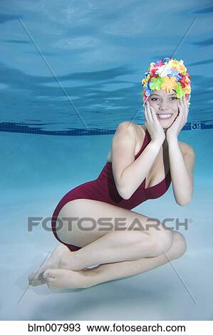Smiling Caucasian woman wearing vintage bathing suit and cap underwater View Large Photo Image Stock Image - Smiling Caucasian woman wearing vintage bathing suit and cap underwater. Fotosearch