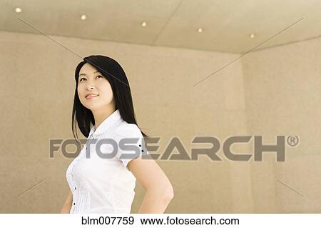 Smiling Chinese businesswoman in office View Large Photo Image Stock Photo - Smiling Chinese businesswoman in office. Fotosearch
