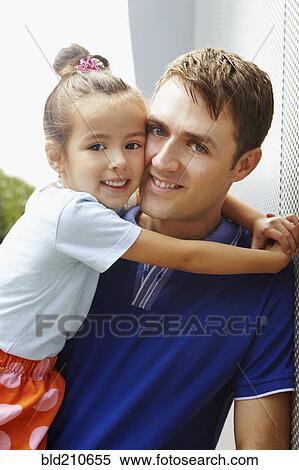 Smiling father holding daughter View Large Photo Image Stock Photography - Smiling father holding daughter. Fotosearch