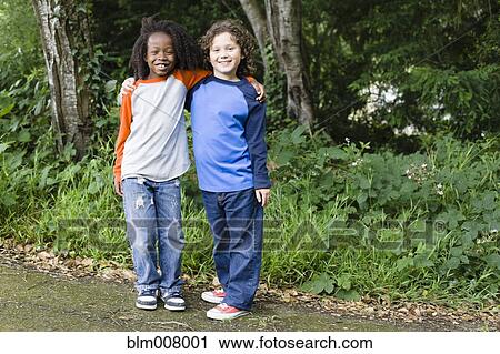 Smiling friends in park View Large Photo Image Stock Image - Smiling friends in park. Fotosearch