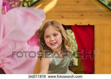 Stock Photograph - Smiling girl in playhouse. Fotosearch