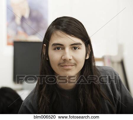 Stock Image - Smiling Hispanic student with long hair. Fotosearch