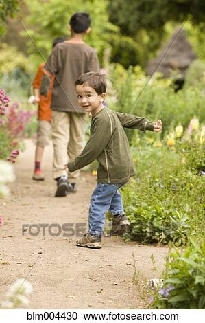Smiling mixed race boy in garden View Large Photo Image Stock Image - Smiling mixed race boy in garden. Fotosearch