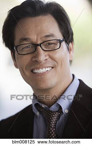 Smiling mixed race businessman wearing eyeglasses View Large Photo Image Stock Photography - Smiling mixed race businessman wearing eyeglasses. Fotosearch