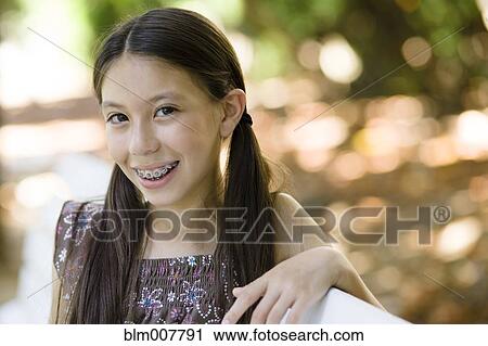 Smiling mixed race girl with braces View Large Photo Image Stock Image - Smiling mixed race girl with braces. Fotosearch