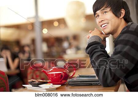 Smiling mixed race man at cafe View Large Photo Image Stock Photograph - Smiling mixed race man at cafe. Fotosearch
