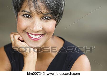 Stock Image - Smiling mixed race woman. Fotosearch