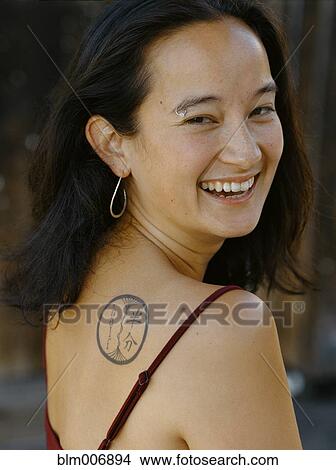 Smiling mixed race woman with tattoo View Large Photo Image Picture - Smiling mixed race woman with tattoo. Fotosearch