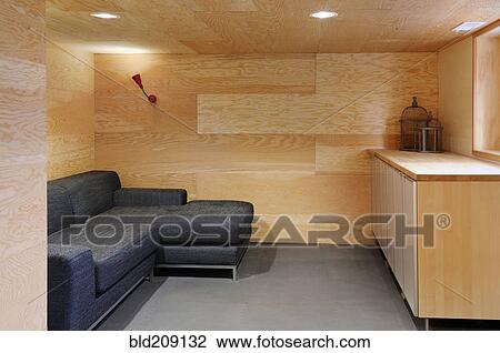 Stock Image - Sofa in wood paneled modern craftsman living room. Fotosearch