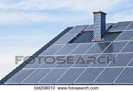 Stock Image - Solar panels on rooftop of house. Fotosearch