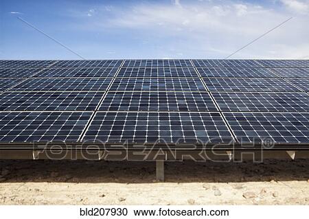 Stock Image - Solar panels under blue sky. Fotosearch
