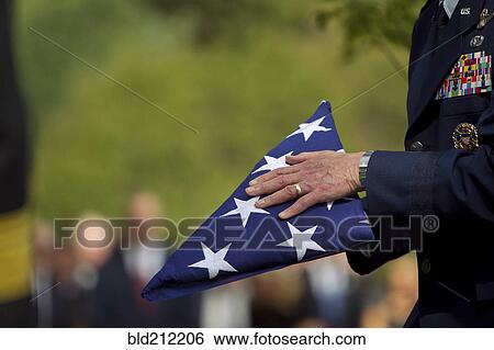 Soldier folding flag at military funeral View Large Photo Image Stock Photograph - Soldier folding flag at military funeral. Fotosearch