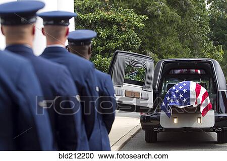 Stock Image - Soldiers watching casket at military funeral. Fotosearch