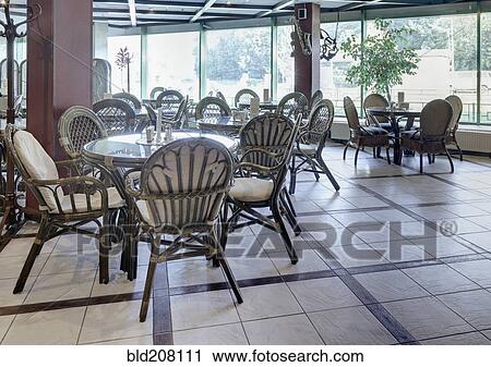 Stock Image - Spacious Cafe With Rattan Furniture. Fotosearch