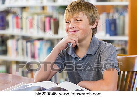 Stock Photograph - Student smiling in library. Fotosearch