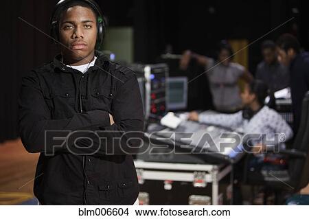 Student standing in headphones View Large Photo Image Picture - Student standing in headphones. Fotosearch
