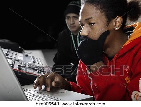 Stock Image - Student working with sound board. Fotosearch