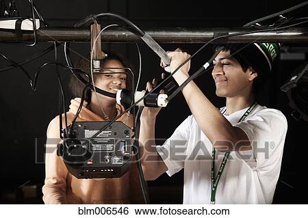 Students adjusting equipment backstage View Large Photo Image Stock Photograph - Students adjusting equipment backstage. Fotosearch