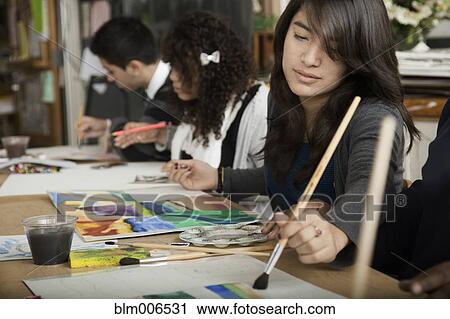 Stock Image - Students painting in classroom. Fotosearch
