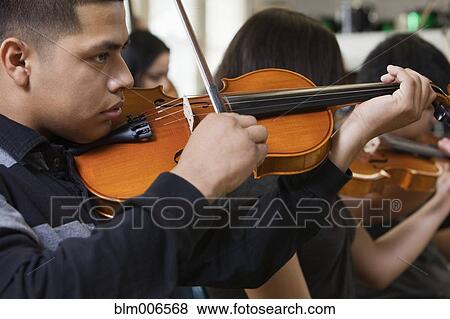 Stock Photo - Students practicing in high school orchestra. Fotosearch