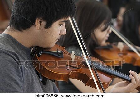 Stock Photograph - Students practicing in high school orchestra. Fotosearch