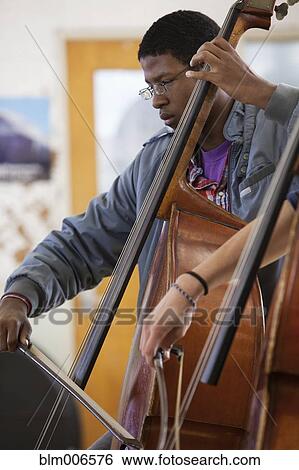 Students practicing in high school orchestra View Large Photo Image Stock Photograph - Students practicing in high school orchestra. Fotosearch