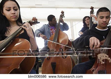 Stock Photograph - Students practicing in high school orchestra. Fotosearch