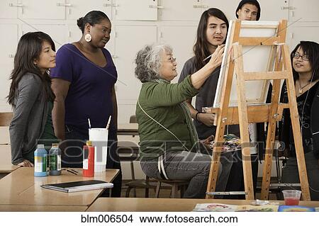 Picture - Students watching teacher in art class. Fotosearch
