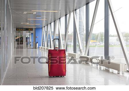 Stock Photography - Suitcase in empty airport corridor. Fotosearch