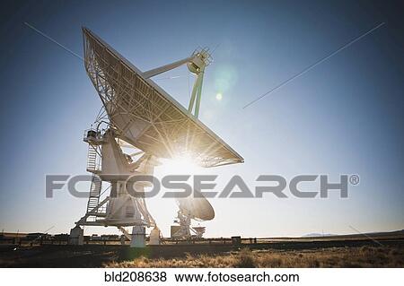 Sun shining behind satellite dish in desert, Socorro, New Mexico, United States View Large Photo Image Stock Photo - Sun shining behind satellite dish in desert, Socorro, New Mexico, United States. Fotosearch