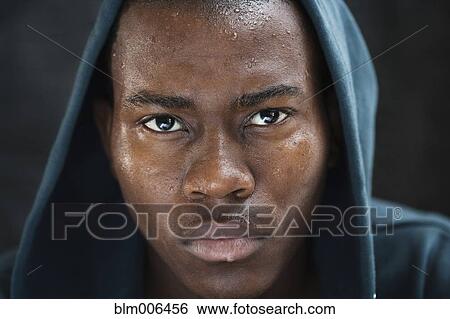 Sweating mixed race man in hoody View Large Photo Image Stock Photograph - Sweating mixed race man in hoody. Fotosearch