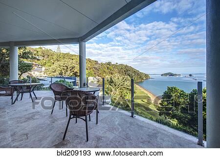 Table and chairs on balcony overlooking Bay of Islands, Paihia, New Zealand View Large Photo Image Stock Image - Table and chairs on balcony overlooking Bay of Islands, Paihia, New Zealand. Fotosearch
