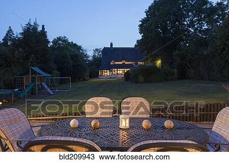 Stock Image - Table and chairs on patio. Fotosearch