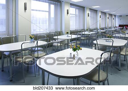 Stock Image - Tables and chairs in empty cafeteria. Fotosearch