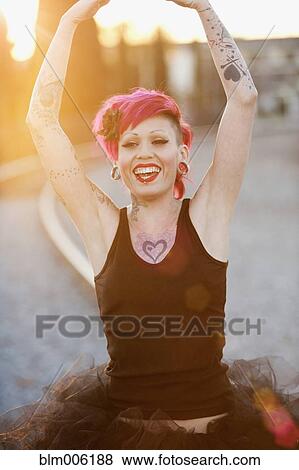Tattooed Hispanic woman in tutu View Large Photo Image Stock Photo - Tattooed Hispanic woman in tutu. Fotosearch
