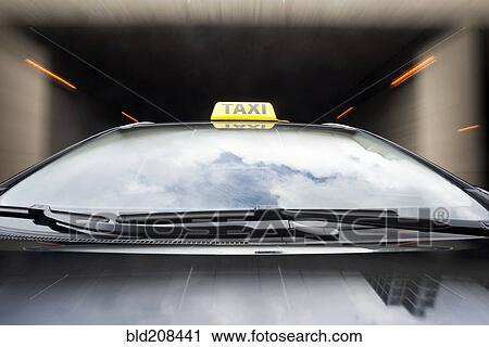 Stock Image - Taxi cab emerging from a tunnel. Fotosearch