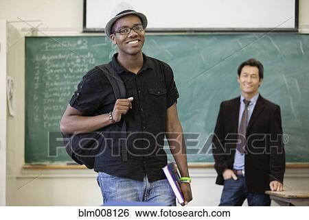 Teacher and high school student in classroom View Large Photo Image Stock Photograph - Teacher and high school student in classroom. Fotosearch